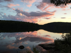 Pink cloudy sunset on Sproule Lake