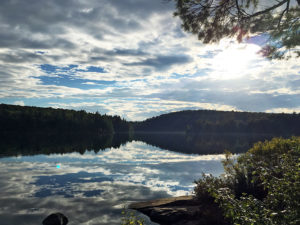 A mix of sun and clouds during a warm afternoon on Sproule Lake