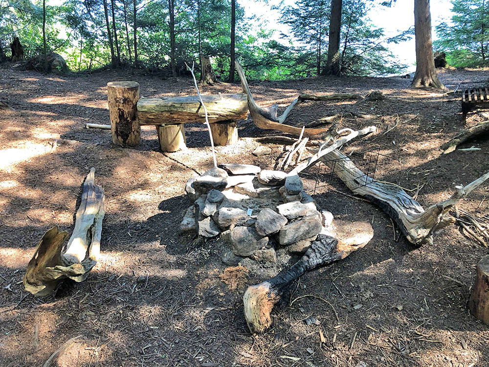 Fire pit and seating on Lake Louisa campsite