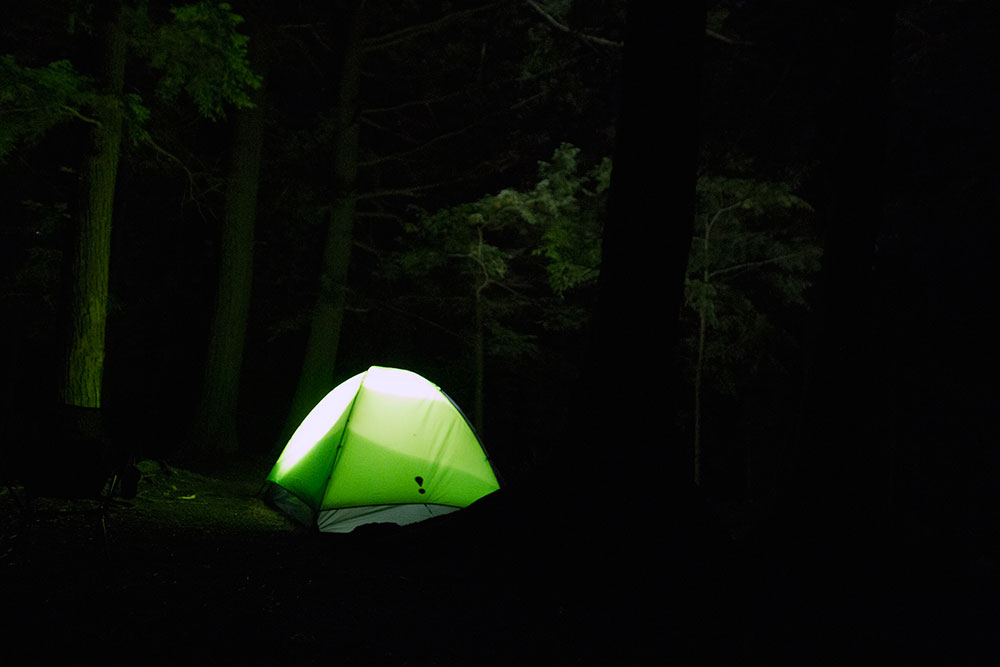 Eureka tent glowing from flashlight at night on Big Trout Lake