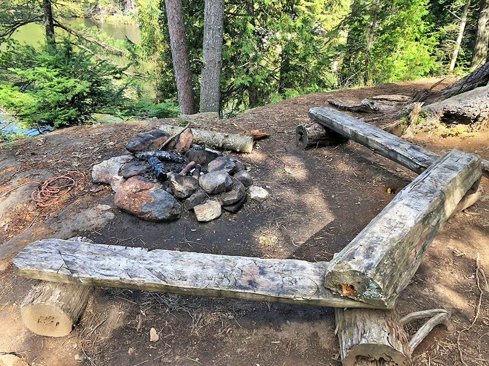 Fire pit and seating area of campsite 37 on Burnt Island Lake in Algonquin Park