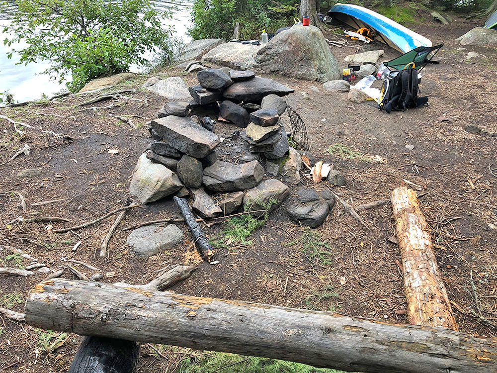 Fire pit and seating area on Otterslide Lake campsite