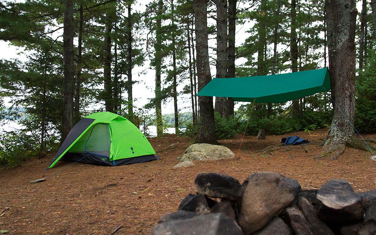 Finding The Best Campsite in Algonquin Park - green tent and green tarp pitched inside of the campsite